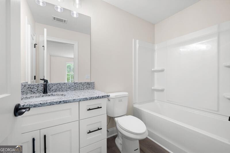 110 Doris Path Dallas, GA 30157 - Photo 29 of 35 a bathroom with a granite countertop toilet a sink and a bathtub
