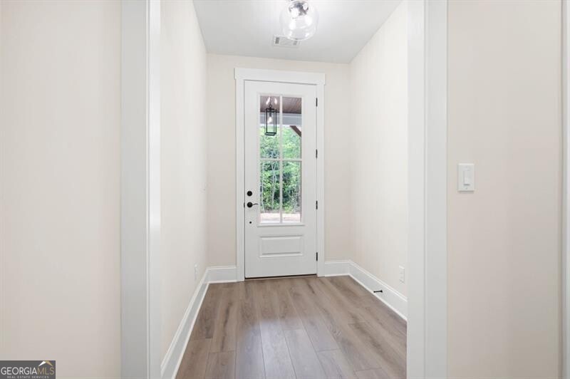 110 Doris Path Dallas, GA 30157 - Photo 6 of 35 an empty room with wooden floor and windows