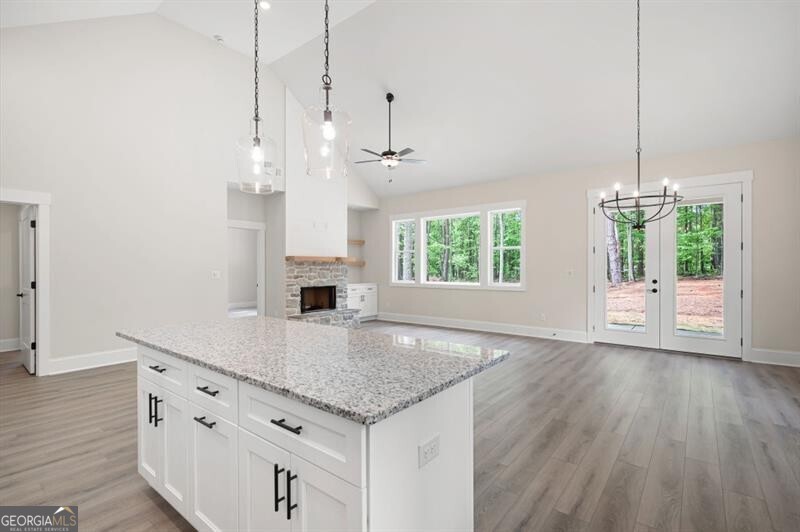 110 Doris Path Dallas, GA 30157 - Photo 10 of 35 a kitchen with kitchen island white cabinets and wooden floor