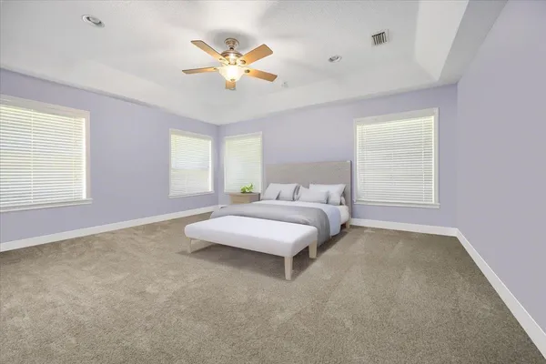 a spacious bedroom with a bed and window