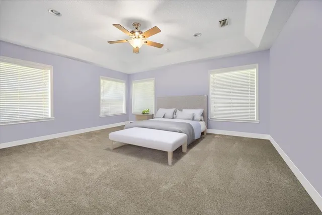 a spacious bedroom with a bed and window