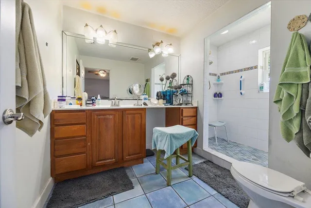 a bathroom with a sink a toilet and a mirror