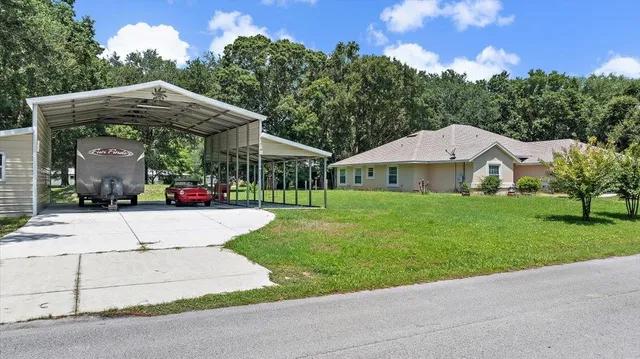 a view of a house with garden and trees