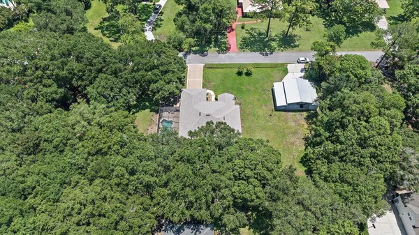 an aerial view of a house with outdoor space and street view