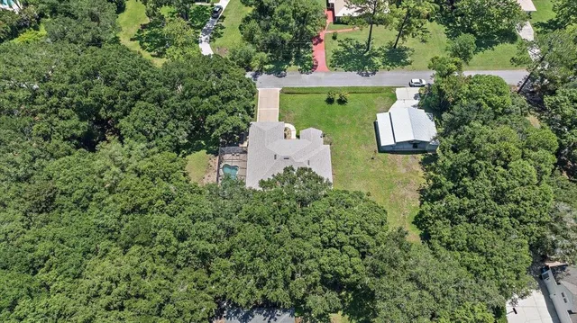 an aerial view of a house with outdoor space and street view