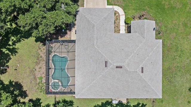 an aerial view of a house with outdoor space and sitting space
