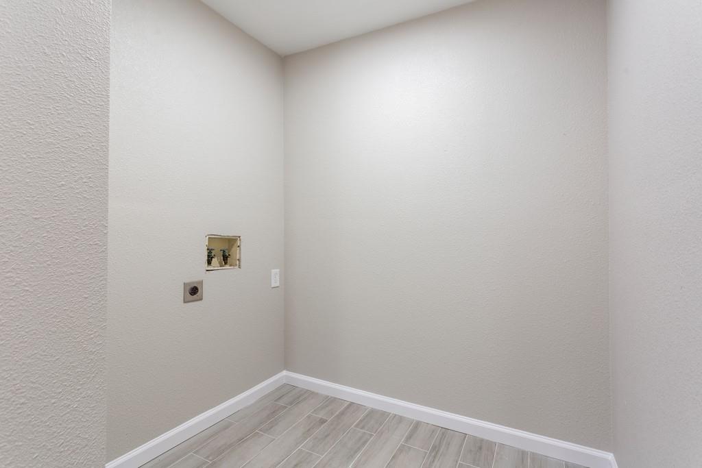 9604 Crown Ridge Road Austin, TX 78753 - Photo 21 of 24 Ready for appliances, this utility space offers convenient hookups and durable flooring.