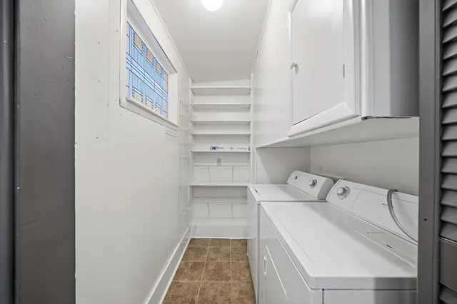 a bedroom with a bed television and a window