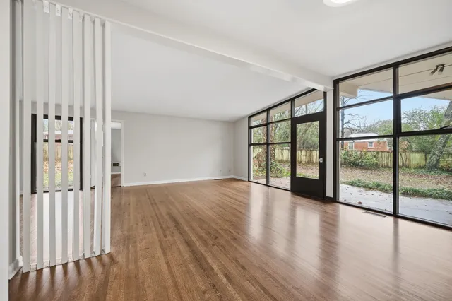 a living room with furniture and a floor to ceiling window