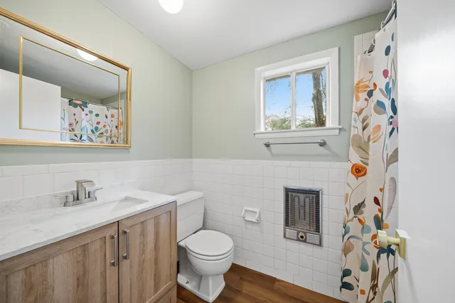 a bedroom with a bed and a potted plant