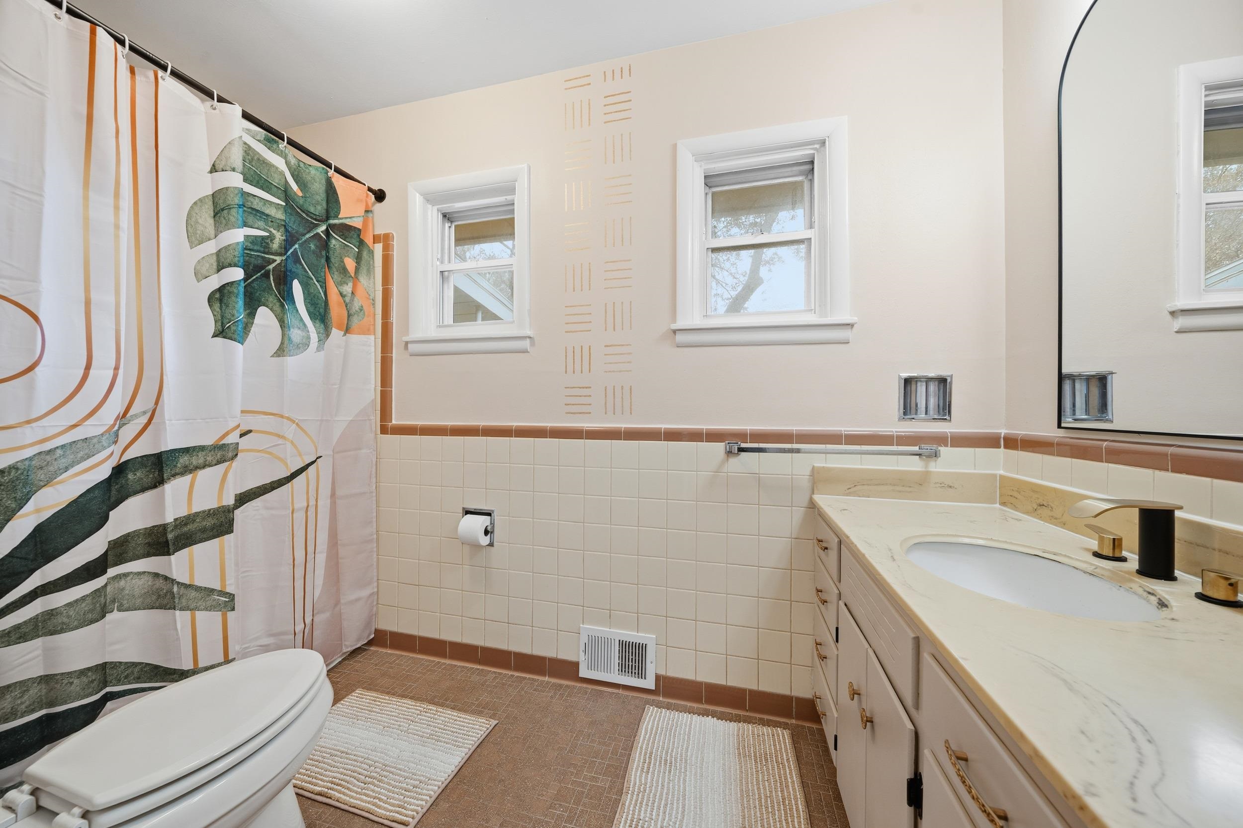 2534 Elmore Park Road Bartlett, TN 38134 - Photo 28 of 35 a bathroom with a sink a toilet and a mirror