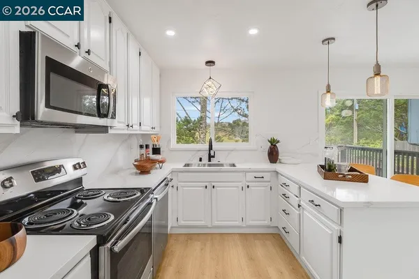 a kitchen with a sink stove and microwave