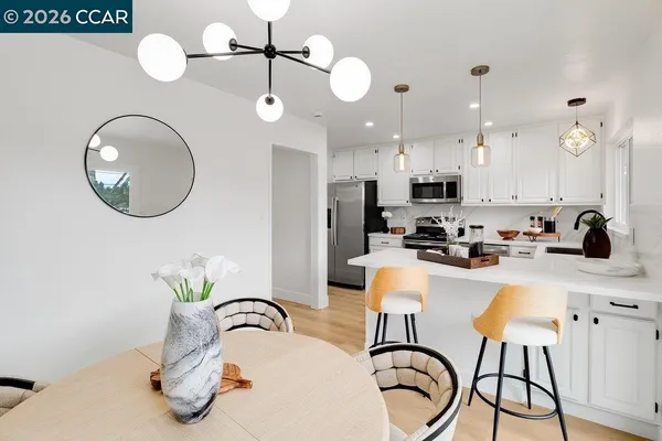 a kitchen with kitchen island granite countertop a sink stainless steel appliances and white cabinets