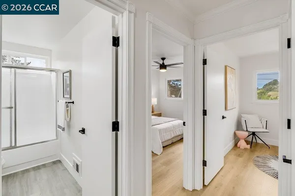 a bedroom with a bed and a painting on the wall