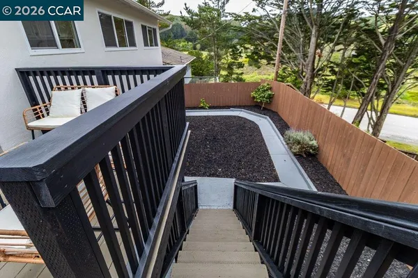 a view of a balcony with wooden floor