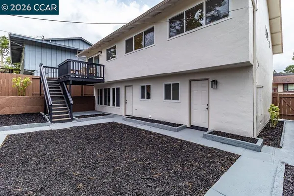 a view of a house with backyard and deck