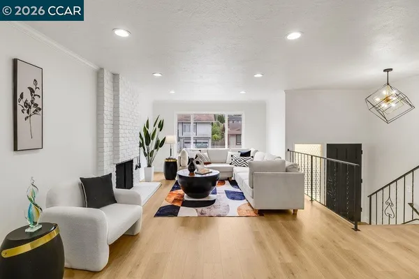 a living room with furniture wooden floor and wall paintings