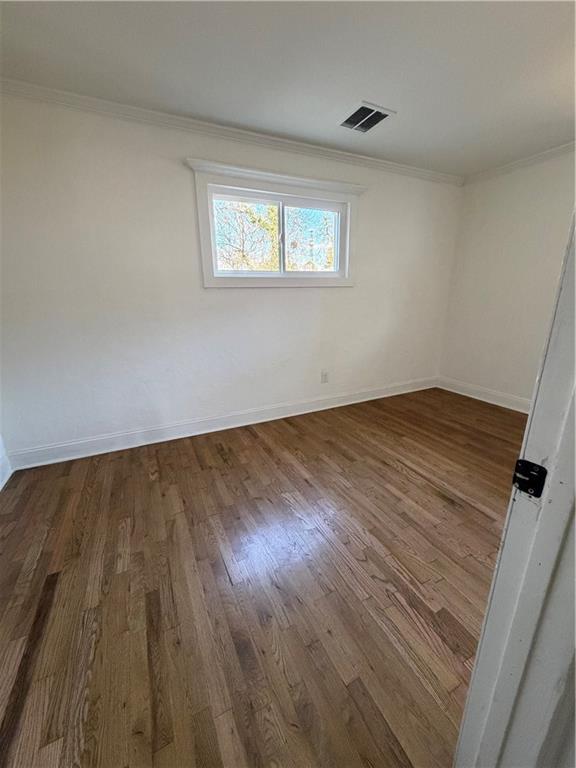 2484 Ortega Way Atlanta, GA 30341 - Photo 16 of 28 a view of an empty room with wooden floor and a window