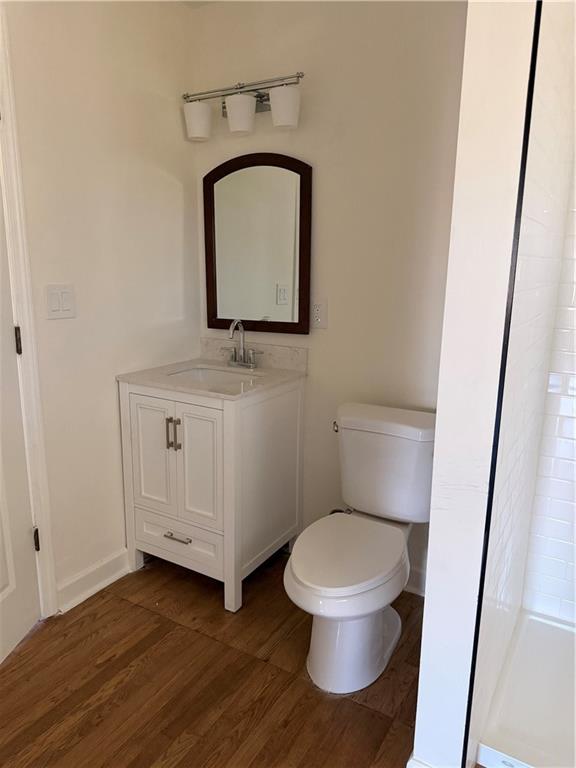 2484 Ortega Way Atlanta, GA 30341 - Photo 21 of 28 a bathroom with a toilet a sink a vanity and mirror