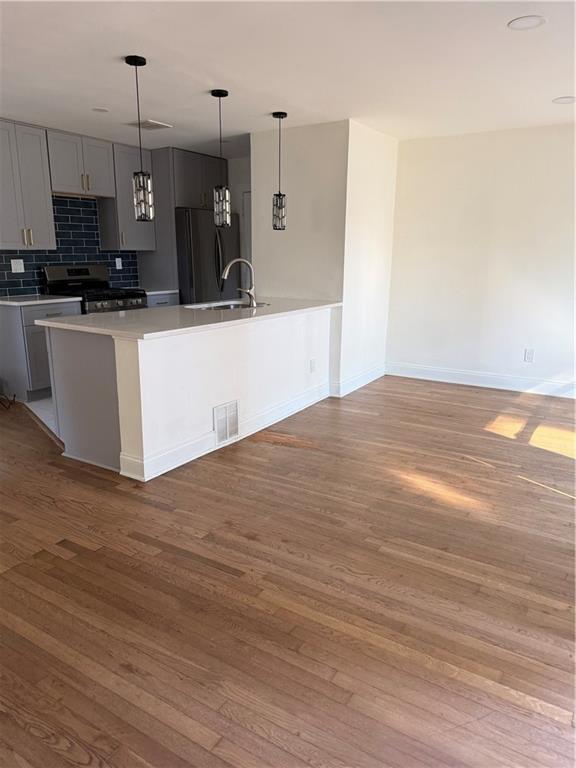 2484 Ortega Way Atlanta, GA 30341 - Photo 3 of 28 a view of a kitchen with kitchen island stainless steel appliances a sink cabinets and wooden floor