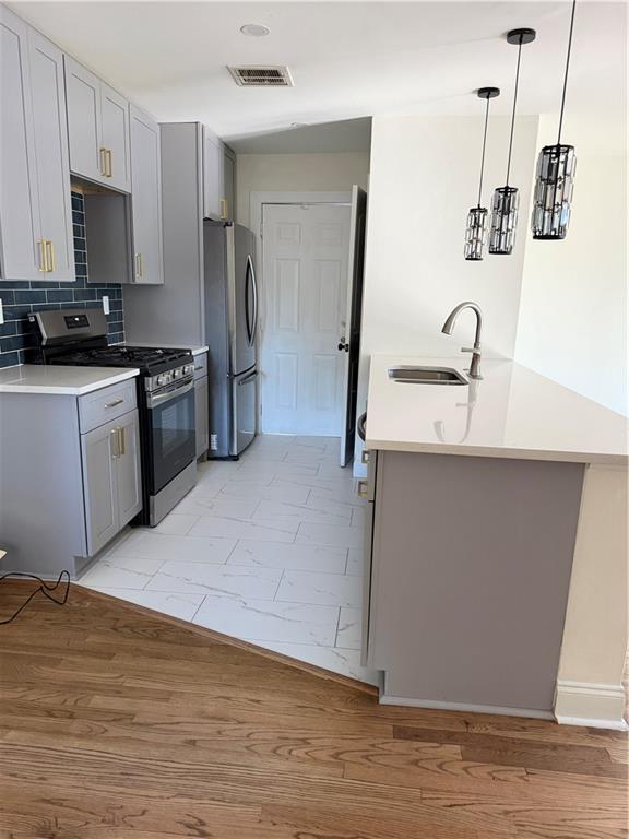 2484 Ortega Way Atlanta, GA 30341 - Photo 5 of 28 a kitchen with stainless steel appliances a sink dishwasher a refrigerator and a stove with wooden floor