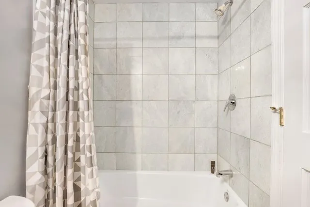 a bathroom with a bathtub and shower