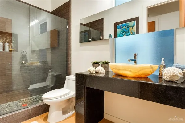 a bathroom with a sink toilet and shower