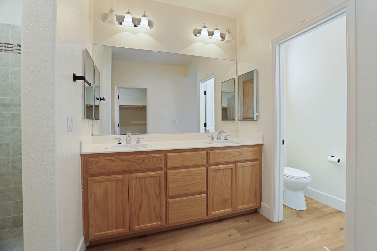 312 Copper Crest Drive Copperopolis, CA 95228 - Photo 15 of 38 a bathroom with a double vanity sink and a mirror