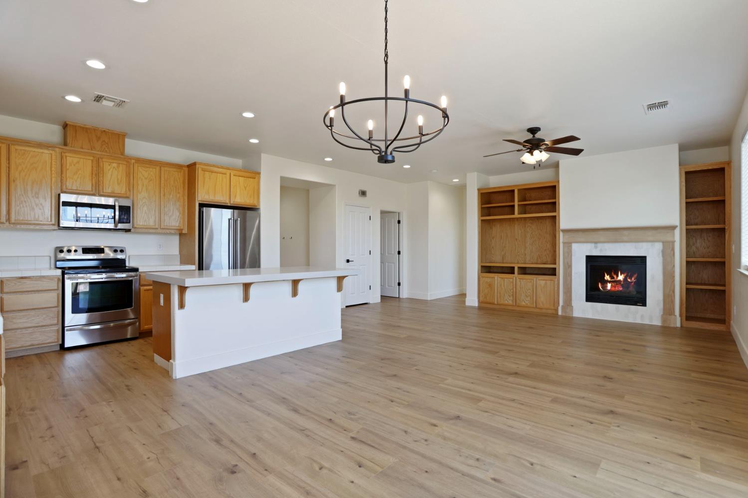 312 Copper Crest Drive Copperopolis, CA 95228 - Photo 22 of 38 a view of a kitchen with a sink stove refrigerator and a fireplace