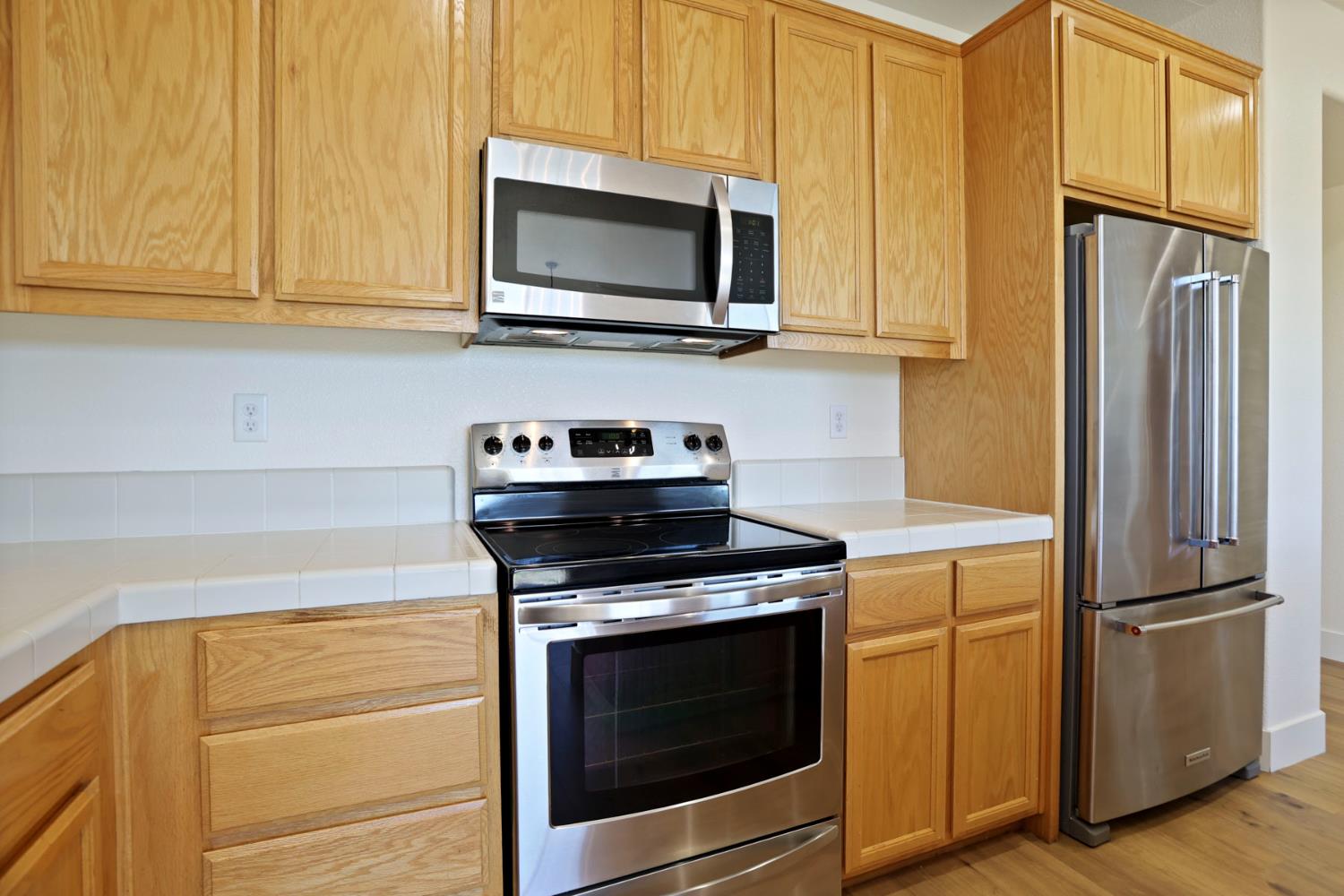 312 Copper Crest Drive Copperopolis, CA 95228 - Photo 30 of 38 a kitchen with stainless steel appliances white cabinets and a stove top oven