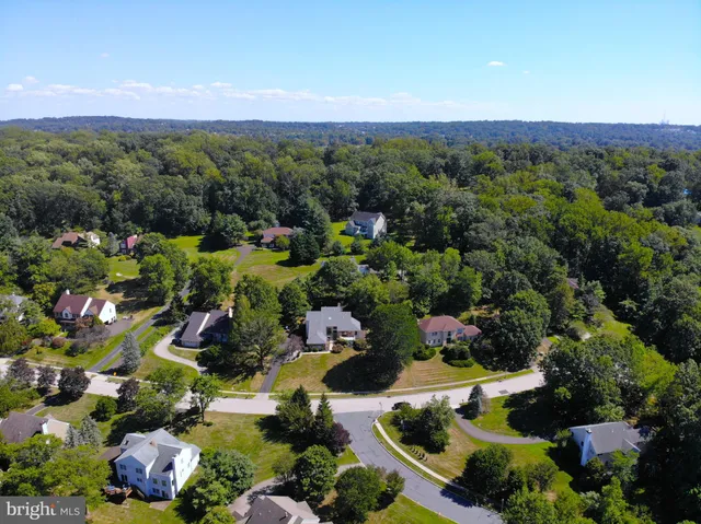 an aerial view of a houses with a yard