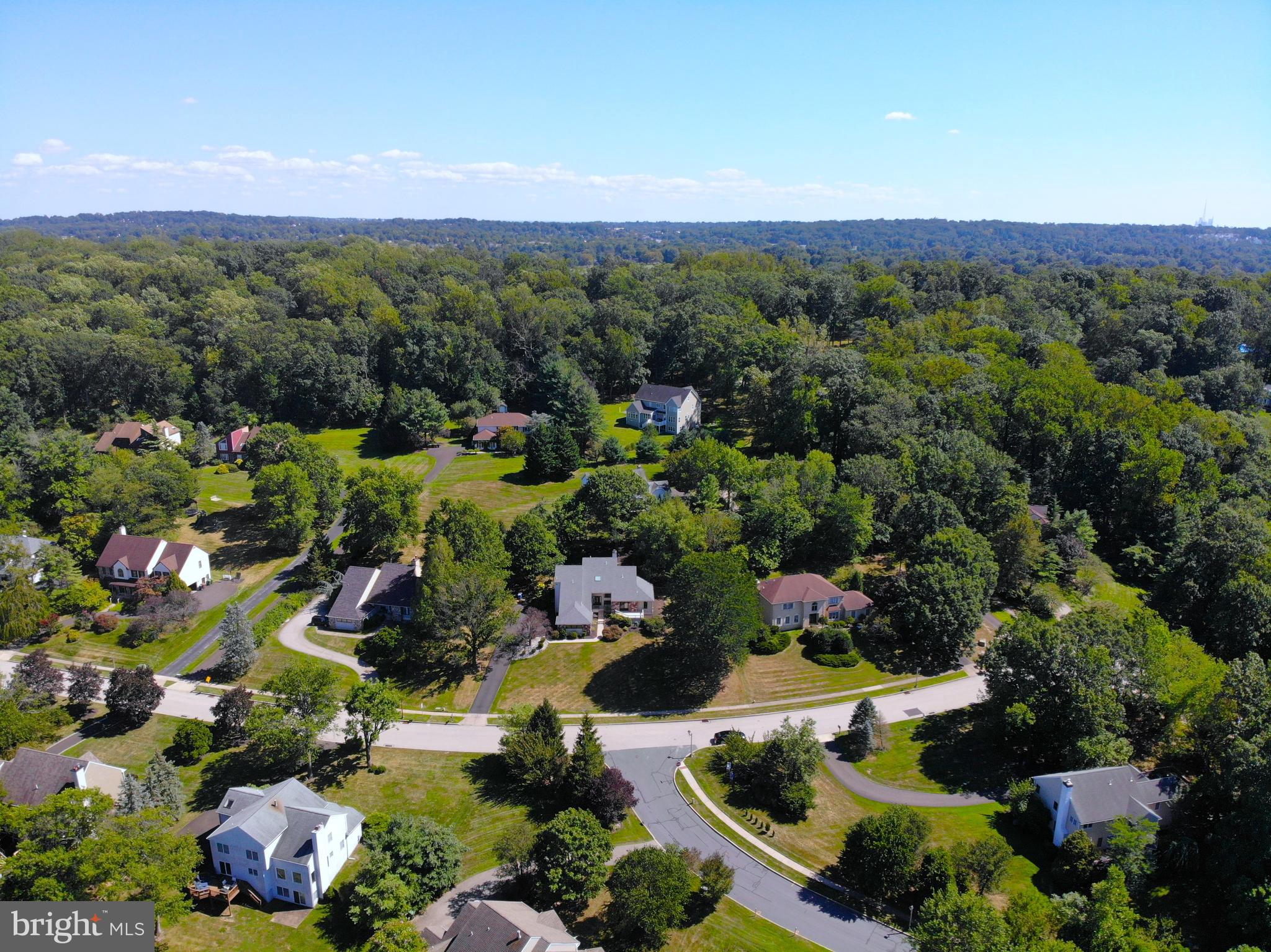 an aerial view of a houses with a yard