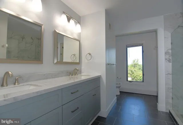 a bedroom with a bed and a mirror