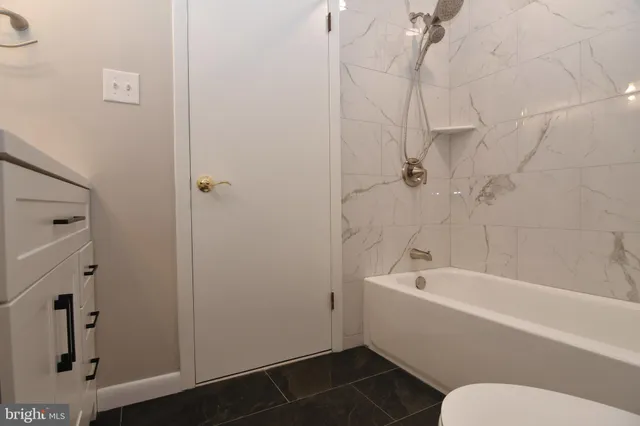 a view of a patio with a dining table and chairs with a small yard