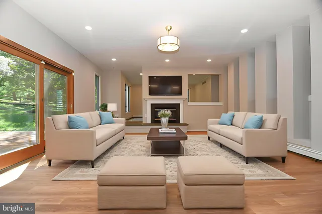 a living room with furniture and a fireplace