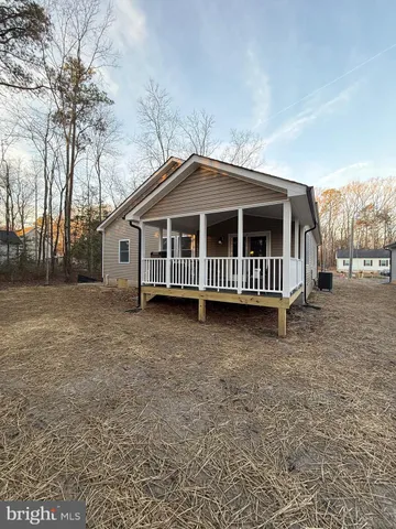 a view of a house with a yard and deck