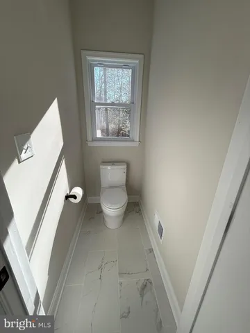 a view of a lake with a yard and large trees