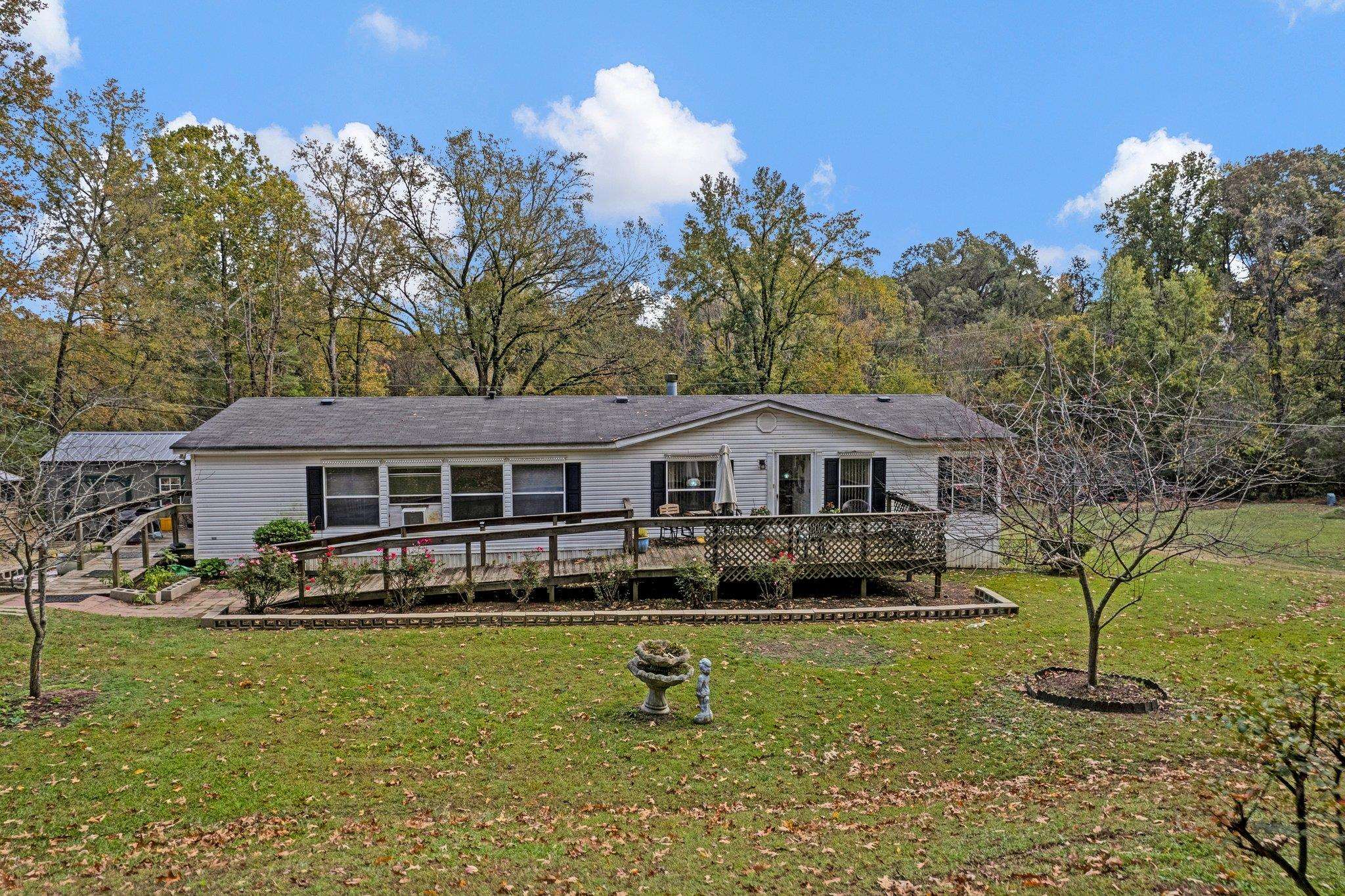 6170 Rust Road Millington, TN 38053 - Photo 6 of 34 a front view of a house with a yard table and chairs
