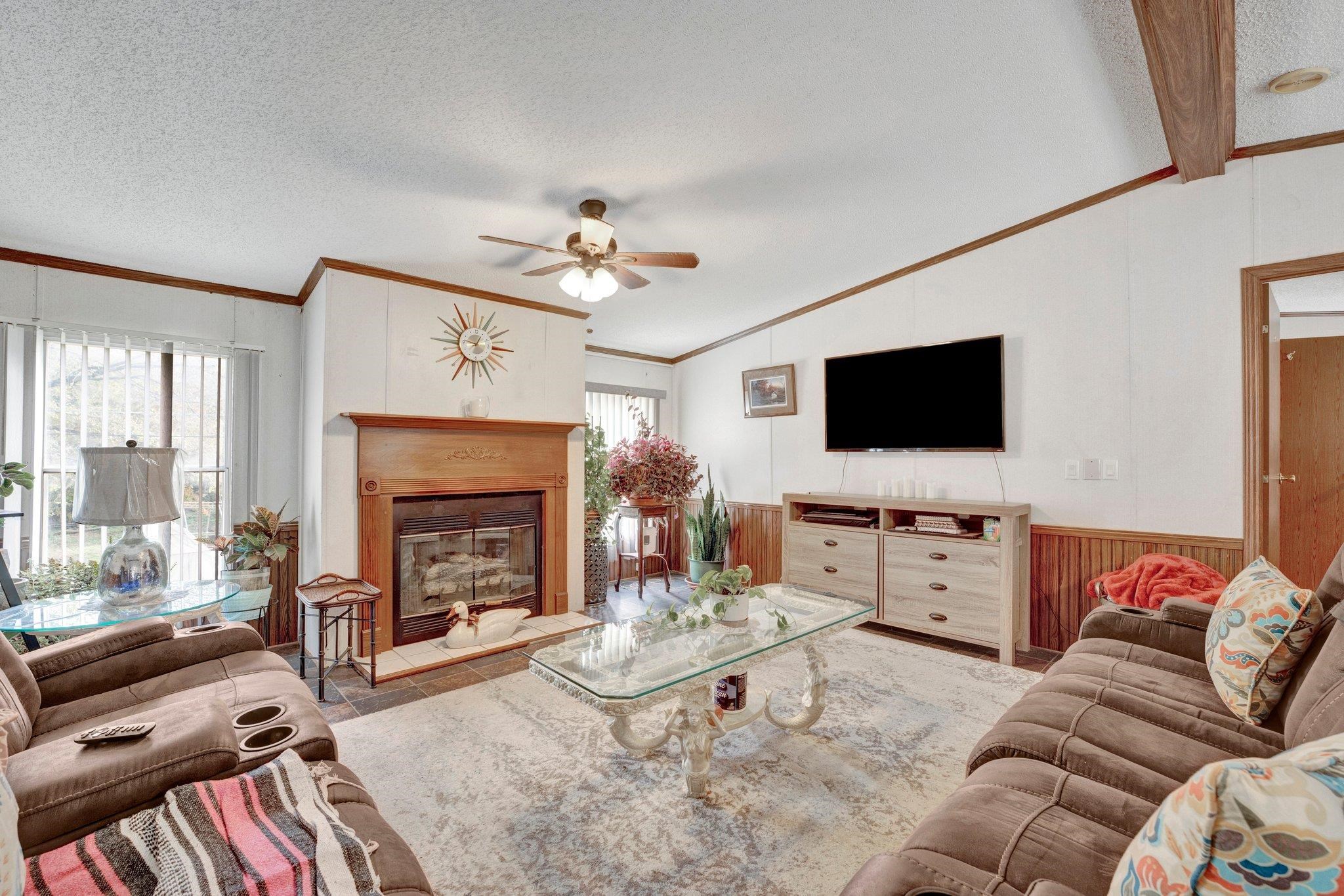 6170 Rust Road Millington, TN 38053 - Photo 8 of 34 a living room with furniture a flat screen tv and a fireplace