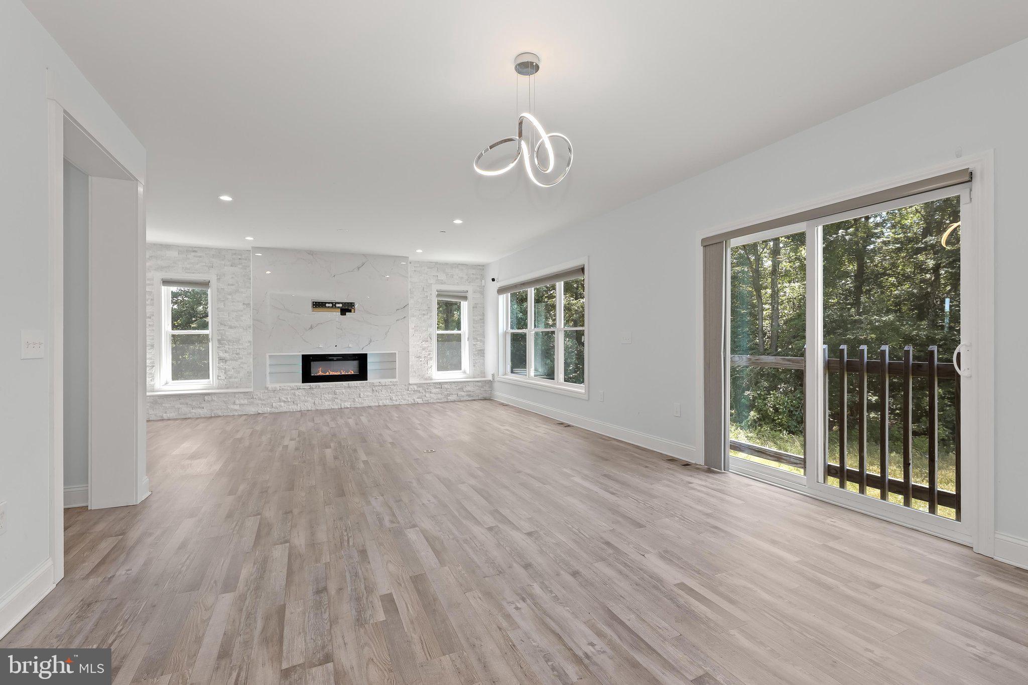 7832 Old Receiver Road Frederick, MD 21702 - Photo 14 of 57 a view of empty room with wooden floor and fireplace