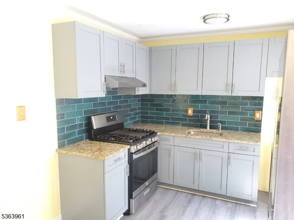 a view of a kitchen from a hallway