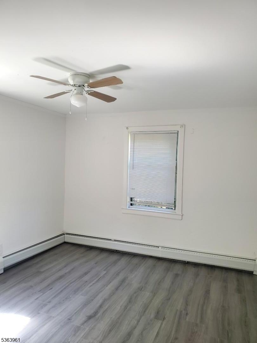 935 East Front Street, Unit C Plainfield, NJ 07062 - Photo 20 of 25 an empty room with wooden floor fan and windows