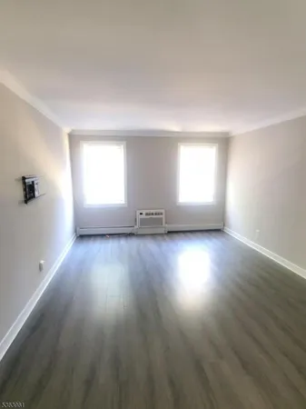a view of an empty room and wooden floor