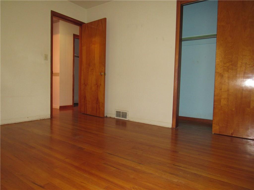 144 Pleasant Hill Road Harmony, PA 16037 - Photo 16 of 31 a view of an empty room with wooden floor and a window