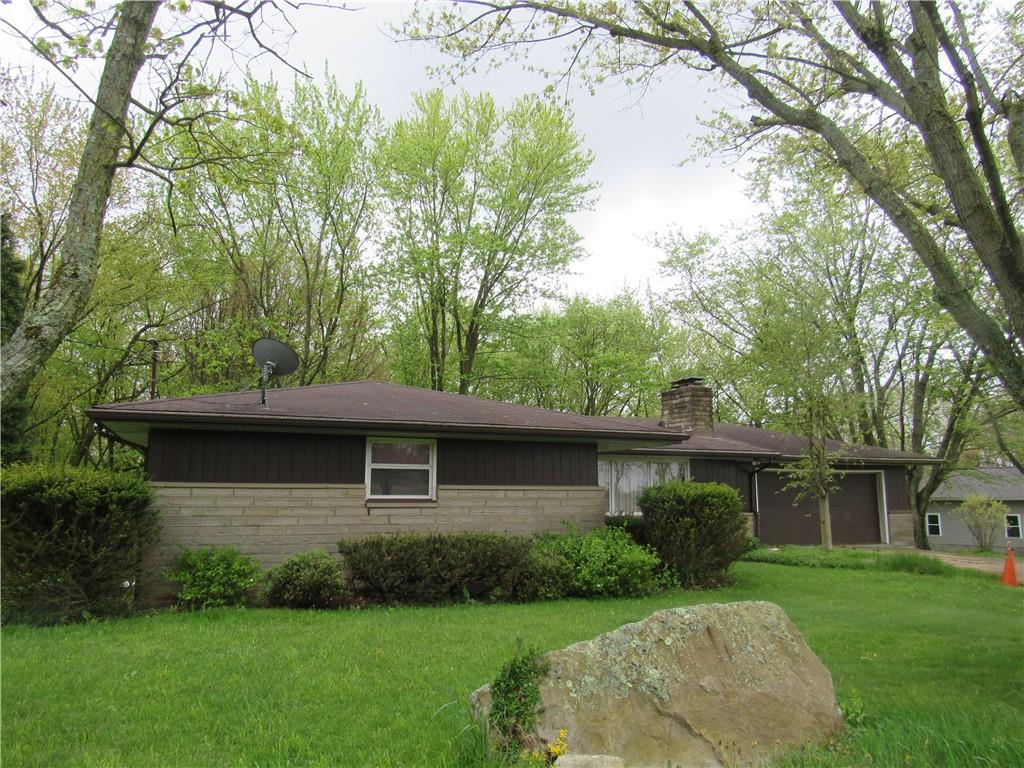 144 Pleasant Hill Road Harmony, PA 16037 - Photo 2 of 31 a front view of a house with a garden