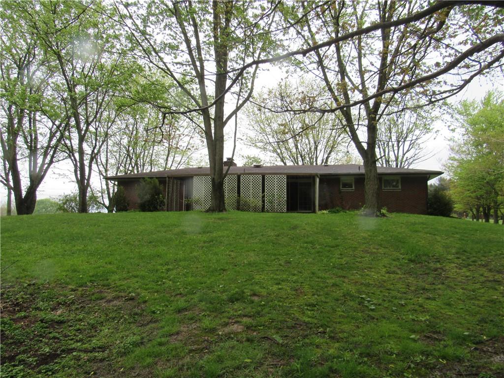 144 Pleasant Hill Road Harmony, PA 16037 - Photo 26 of 31 a front view of a house with a yard and trees