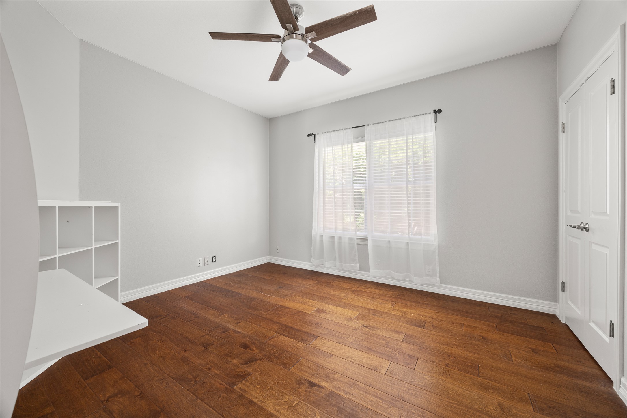 9300 Simmons Road Austin, TX 78759 - Photo 8 of 17 Rich hardwood floors complement light walls, creating a versatile and comfortable living space.