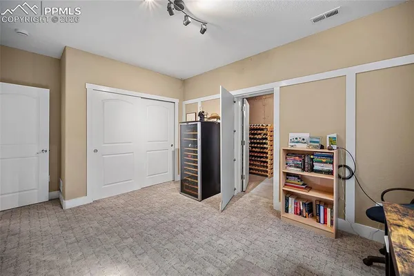 a view of a bedroom with furniture and closet