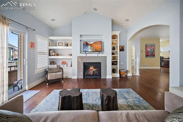 a living room with furniture and a fireplace