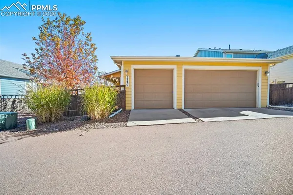a view of a house with a yard and garage